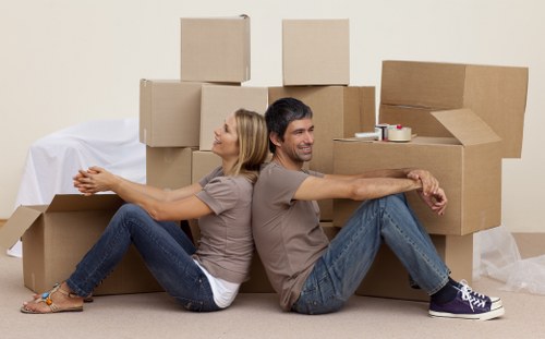 Professional movers securing boxes inside a removal van