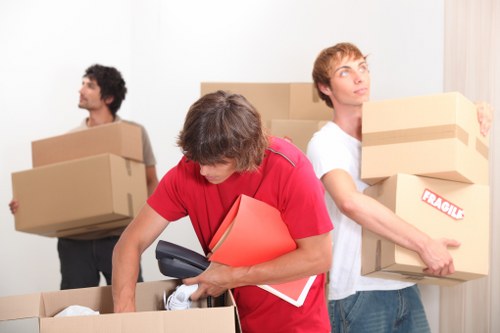 Removal team handling furniture in a West London flat