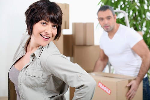 Professional movers packing office equipment for relocation